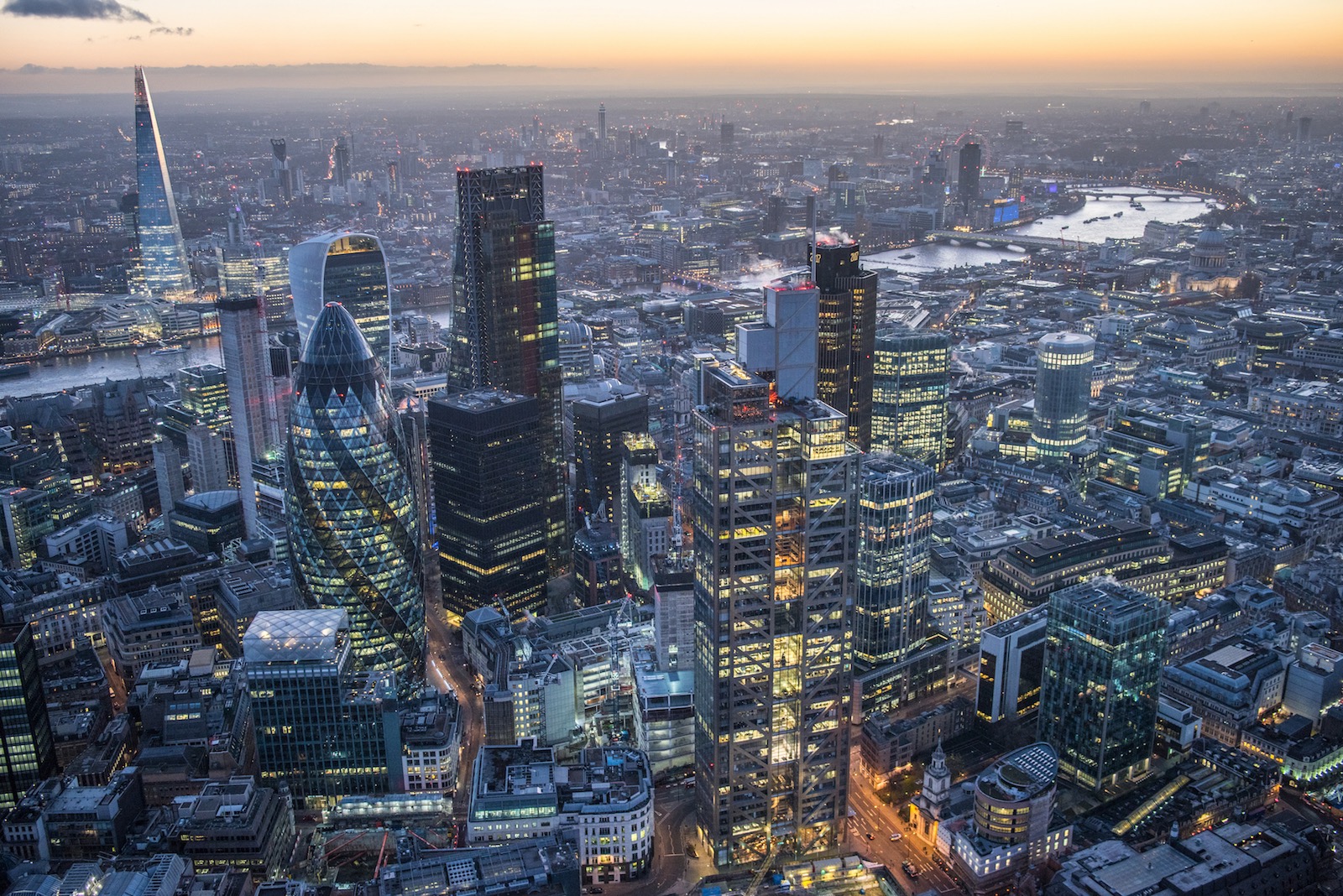 Dusk aerial viewover the City of London. Heron Tower / Sales Force Tower, Swiss Re Tower, The Leadenhall Building, The Shard, skyscrapers of London. England, UK .Aerial view .