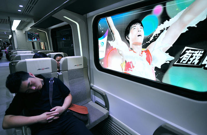 A passenger naps in the train on the new